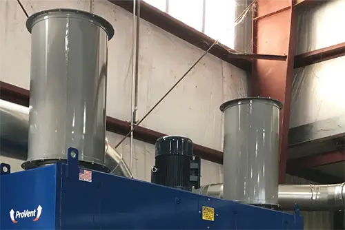 Grey painted silencers installed on top of blue painted machine.