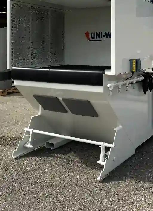 Uni-Wash industrial dust collector featuring a footrest, knee pads, and compressed air manifold, designed for ergonomic use and effective air filtration in industrial environments.