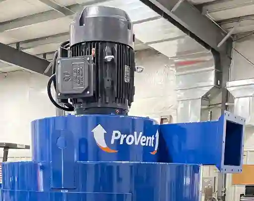 Fan Assembly Close-up of a ProVent industrial motor mounted on top of a Uni-Wash dust collector, showing detailed motor housing and wiring components.