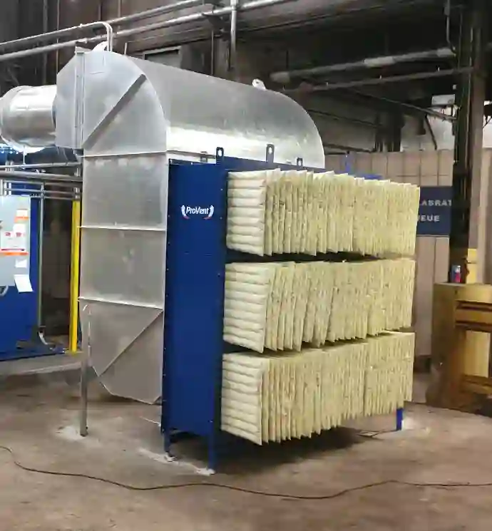 ProVent industrial air filtration unit with multiple layered filters and connected ductwork, designed for dust and particle collection in a factory setting.