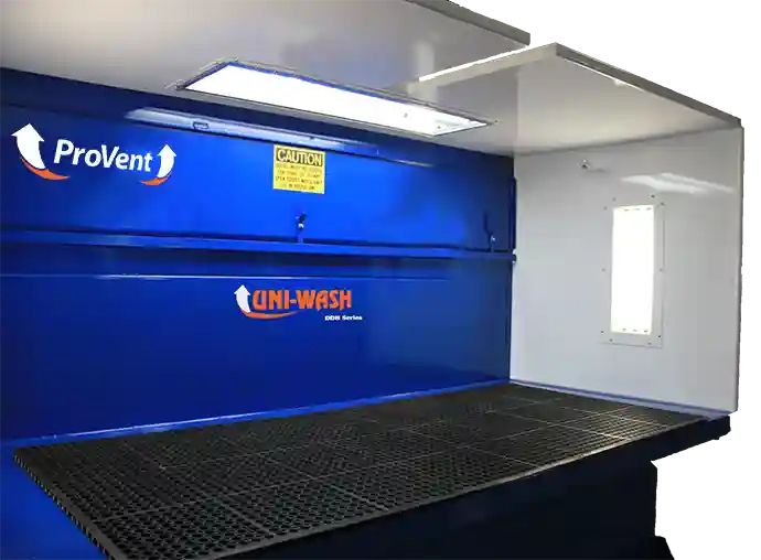 ProVent Uni-Wash DDB Series industrial dust collection unit with grated work surface, enclosed side panels, and overhead lighting, designed for efficient air filtration and dust control.