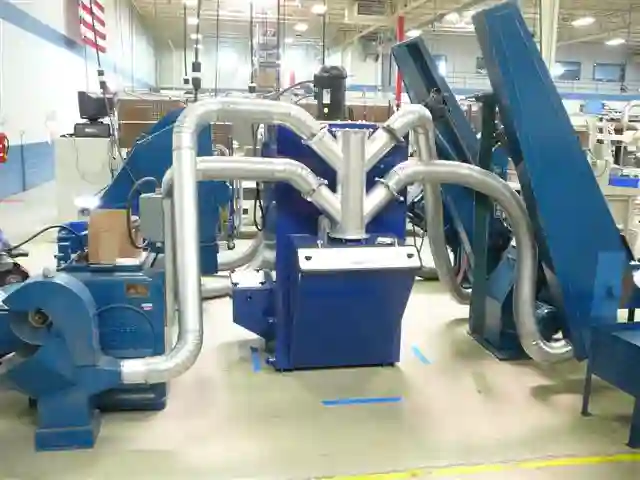 ProScrub connected to multiple machines ProScrub connected to four machines with a duct manifold coming off the ProScrub in an industrial shop setting