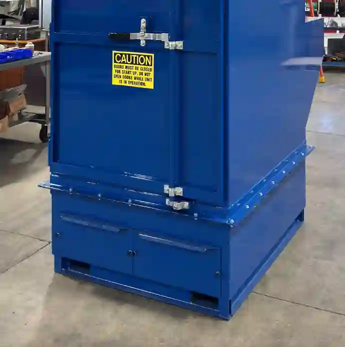 Industrial air filtration unit with closed access doors and dual dust drawers at the bottom for easy access and maintenance, enhancing dust collection efficiency in a blue metal cabinet.