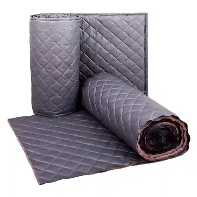 Rolled and flat sheets of quilted sound-absorbing material, commonly used for noise reduction in industrial settings.
